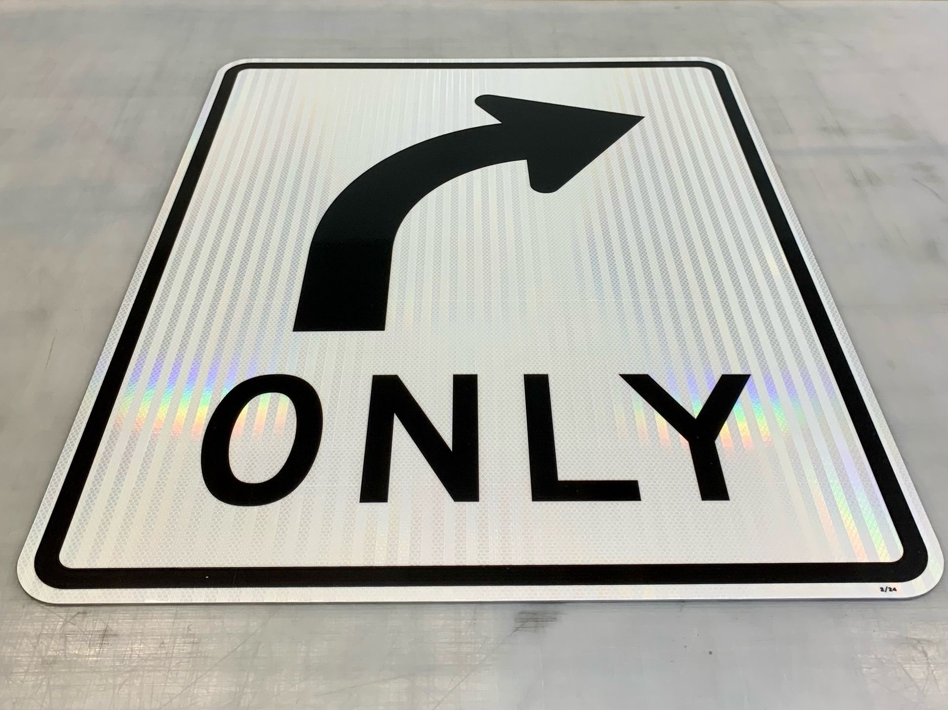 A white sign with a black arrow and the word only on it