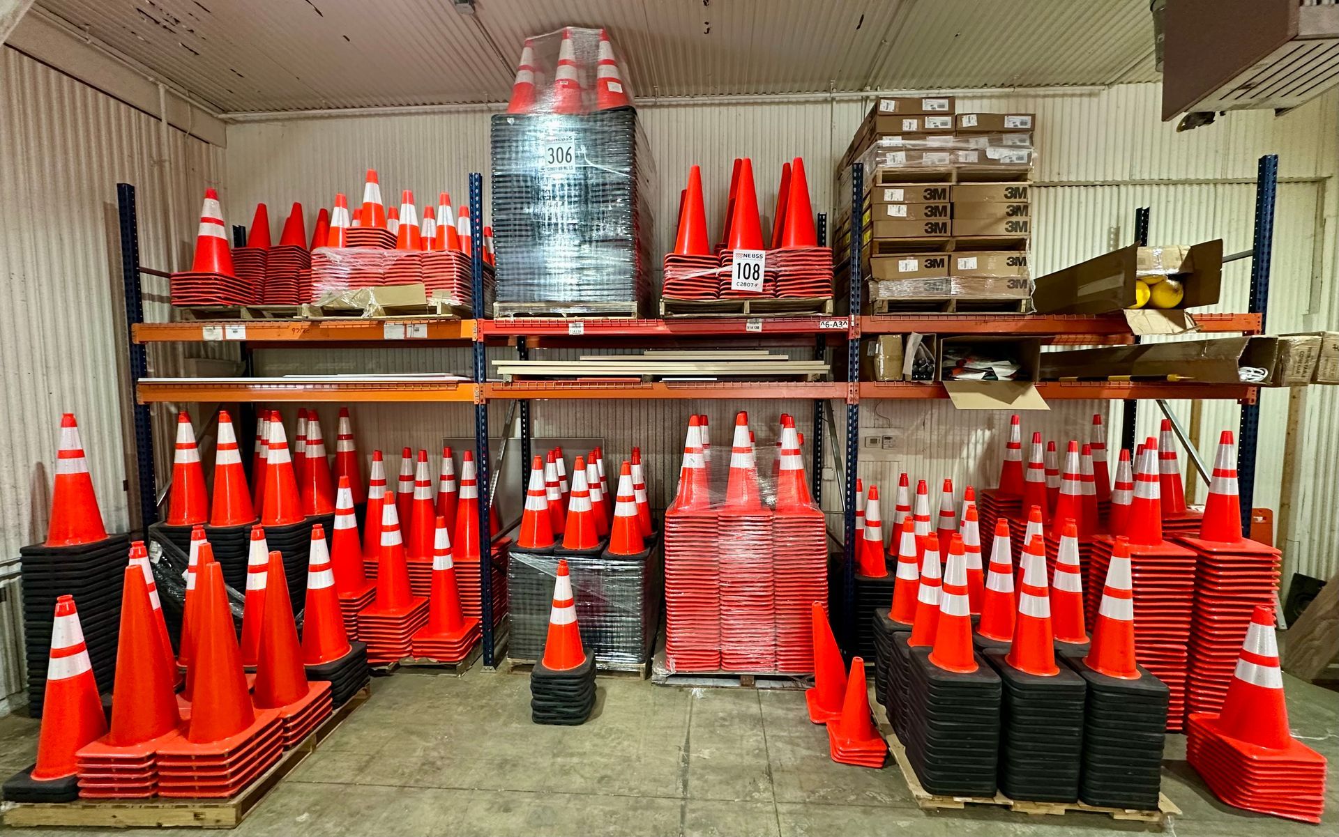 A warehouse filled with lots of traffic cones on shelves.