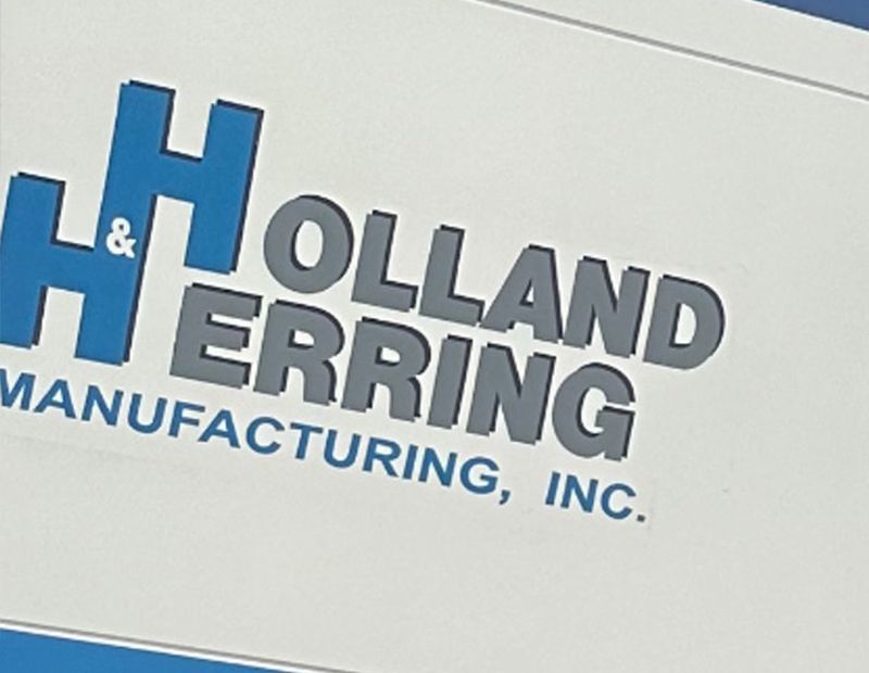 A close up of a Holland Herring manufacturing sign. (After)
