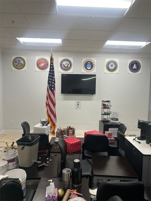 A room with a flag and a television on the wall.
