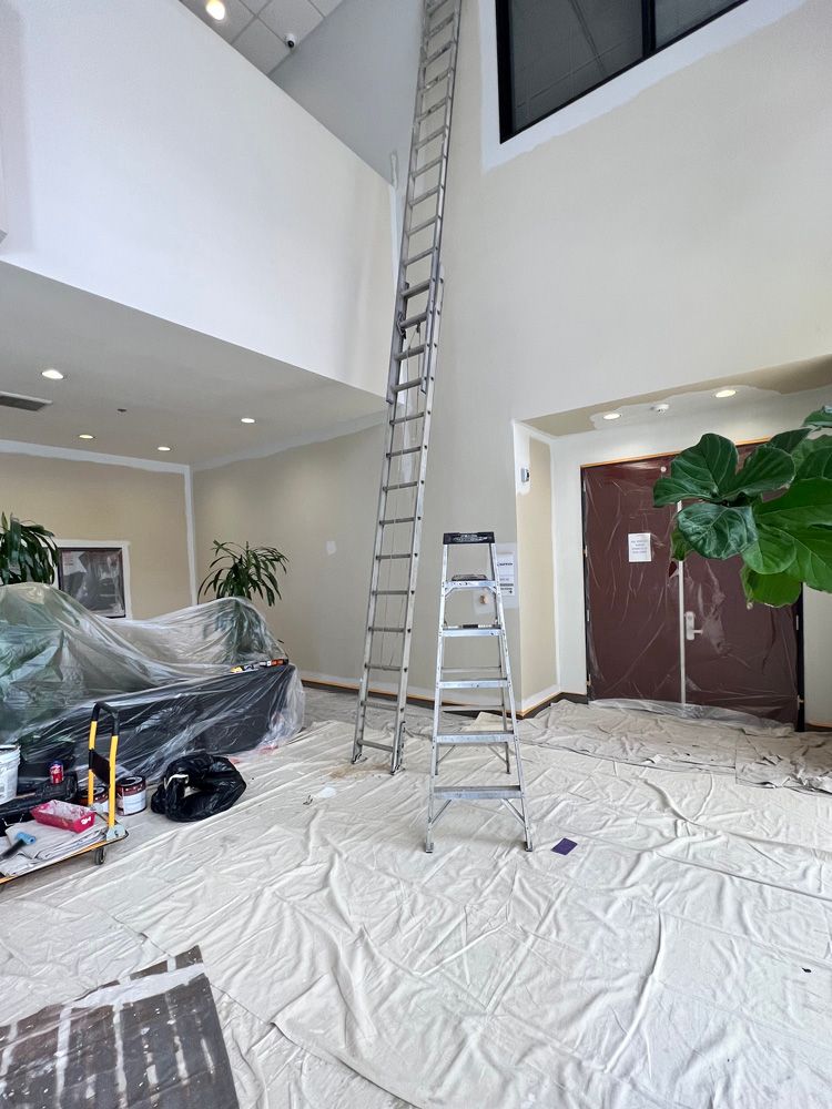 A ladder is hanging from the ceiling of a room.