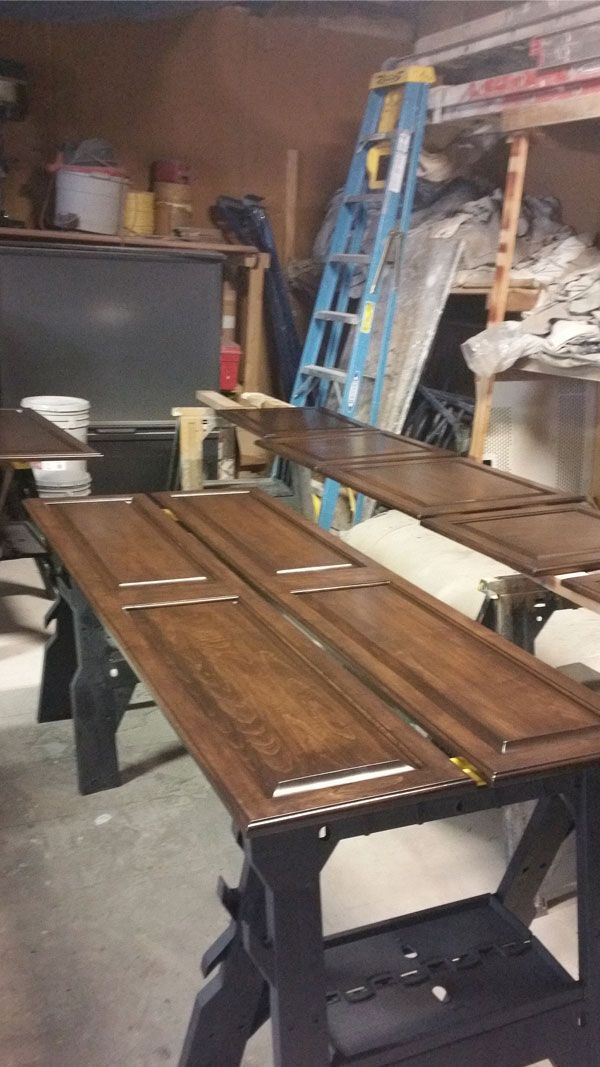 A wooden table is sitting in a garage next to a ladder.