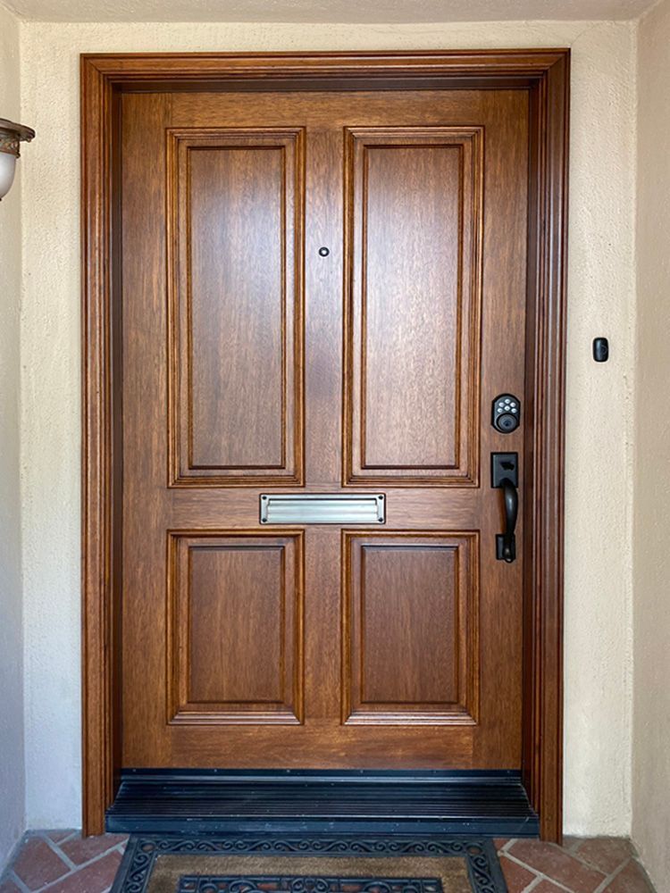 The front door of a house is made of wood