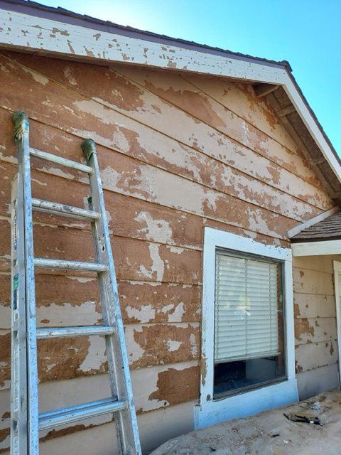 A ladder is leaning against the side of a house.