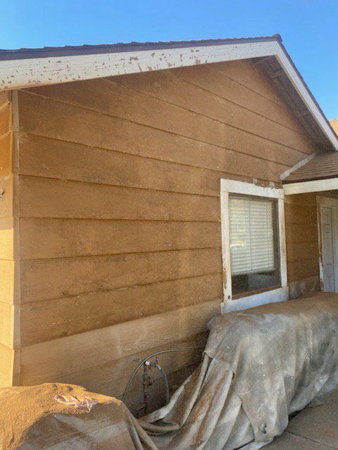 A house with a car cover on the side of it.