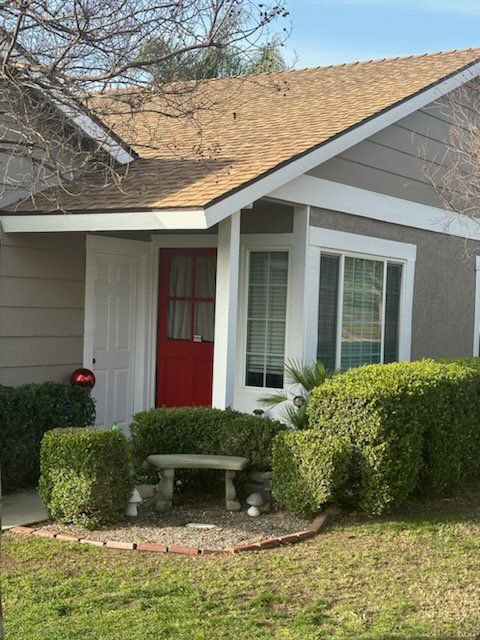 A small house with a red door and white trim.