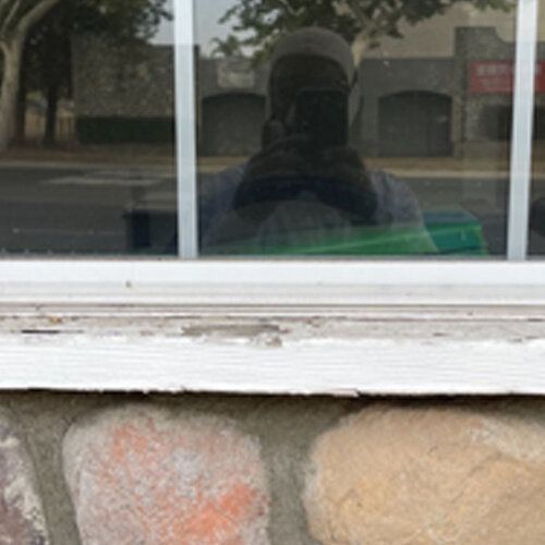 A man is taking a picture of himself in a window.