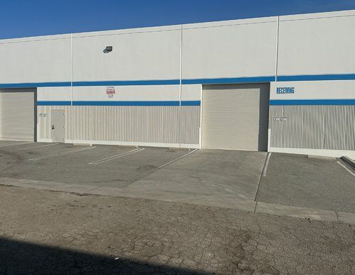 A white building with blue stripes and the number 8376 on the side.