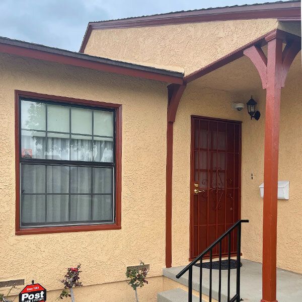 A house with a porch and a sign that says post.