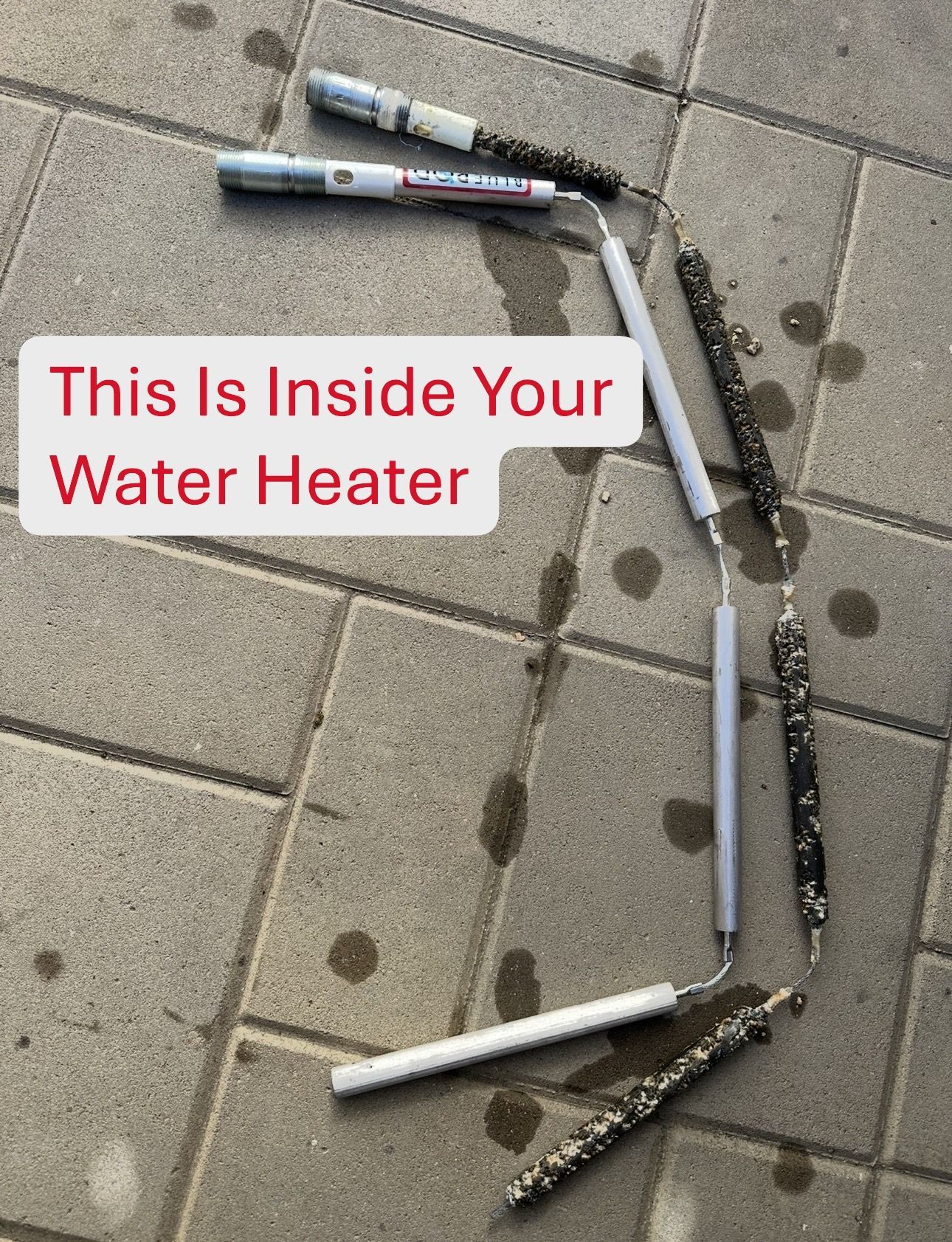 Depleted water heater anode rod next to a new anode rod showing corrosion and wear