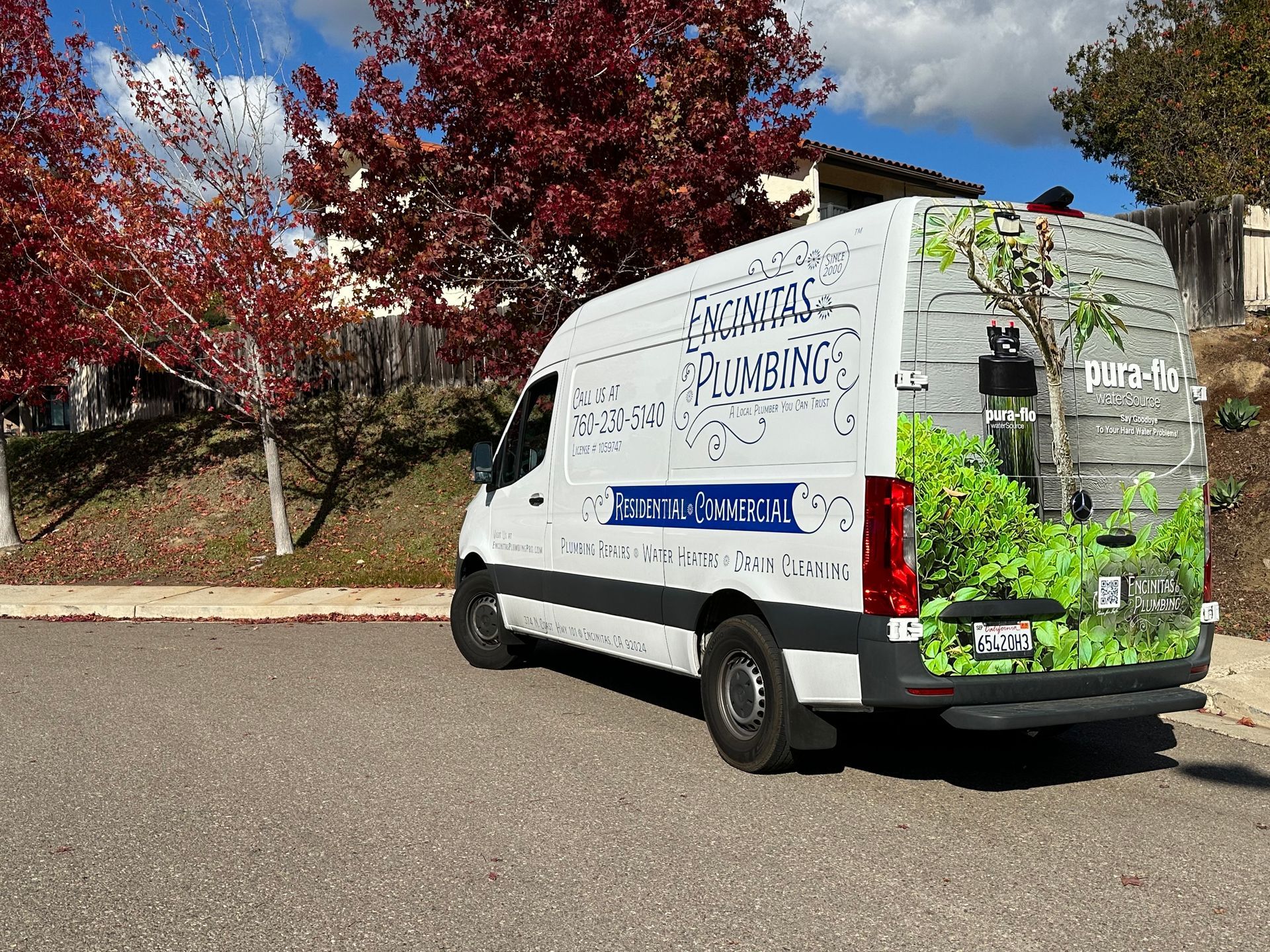 Encinitas Plumbing service van with Pura-Flo descalePLUS water conditioning advertisement on rear
