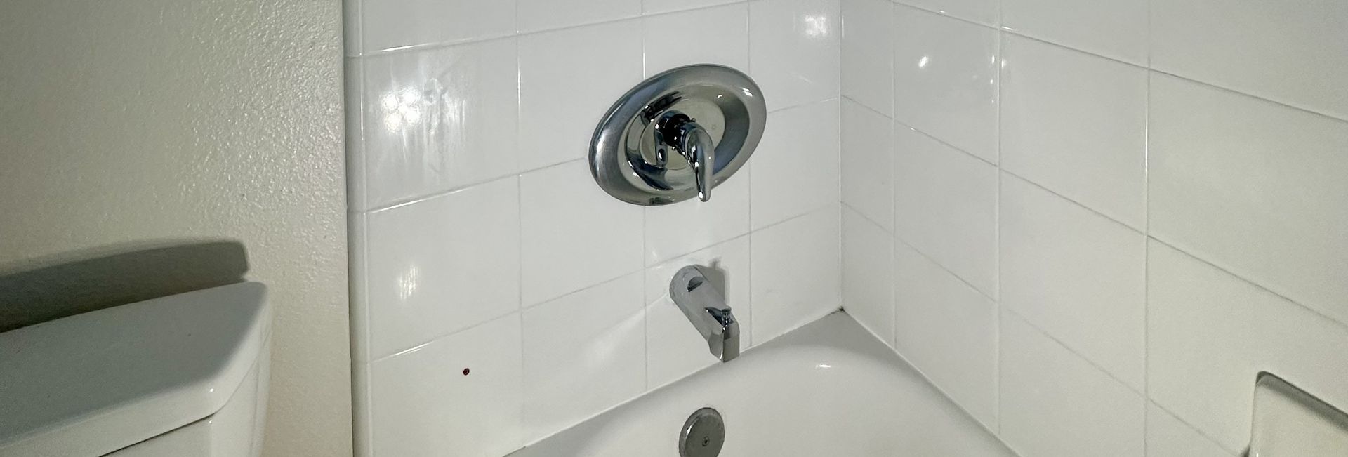 Close-up of tub-shower valve and spout showing signs of a leak during repair in Encinitas, CA