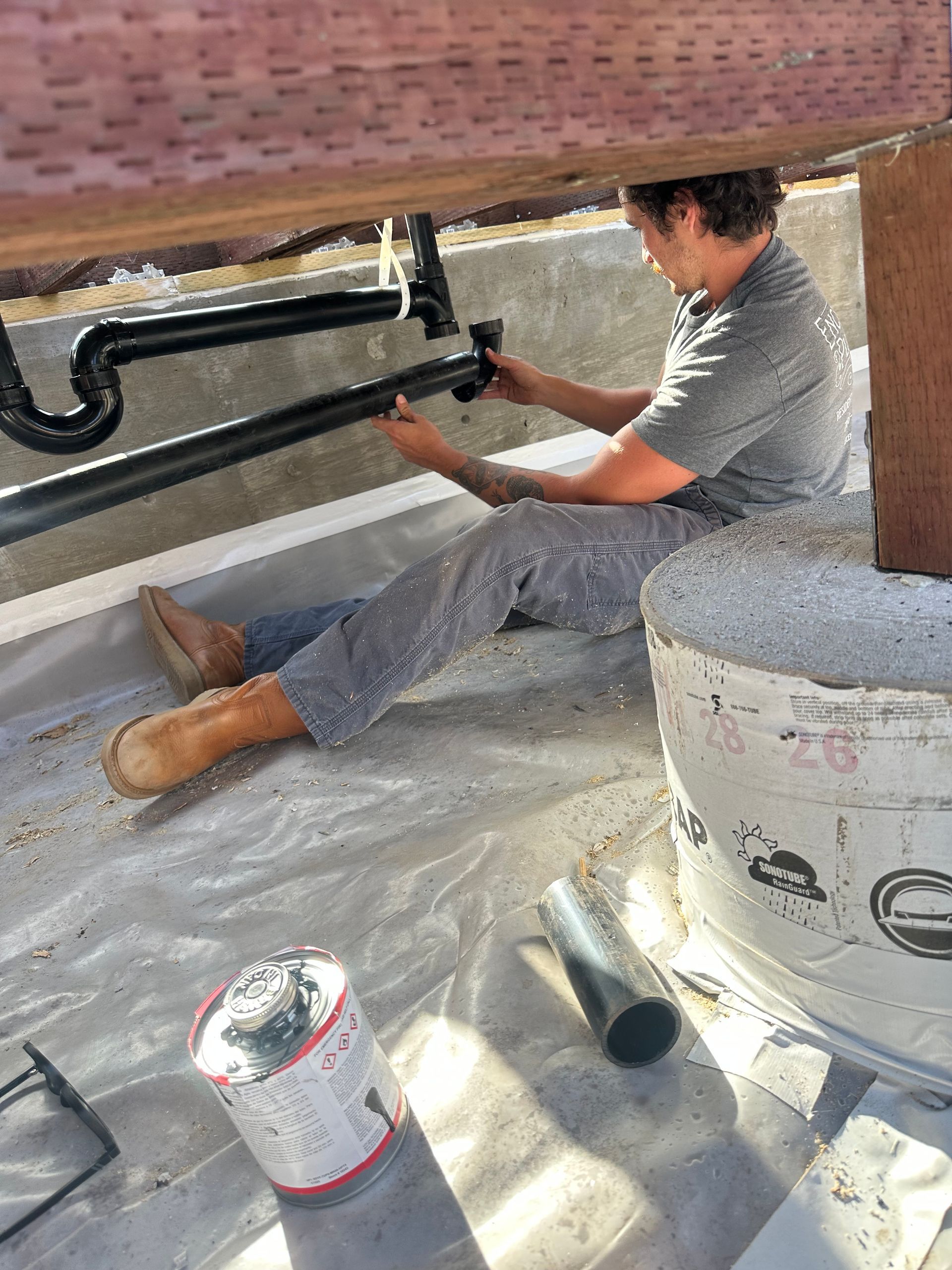 Encinitas Plumbing technician installing rough plumbing and a shower drain system during a bathroom remodel in Vista, CA.