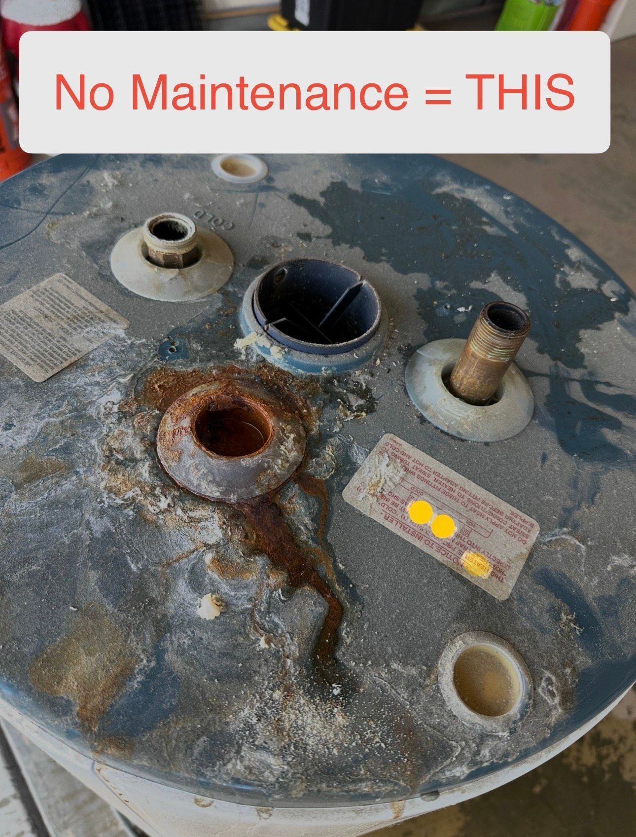 Severely corroded water heater top with rust and mineral buildup from lack of maintenance in Encinitas, CA
