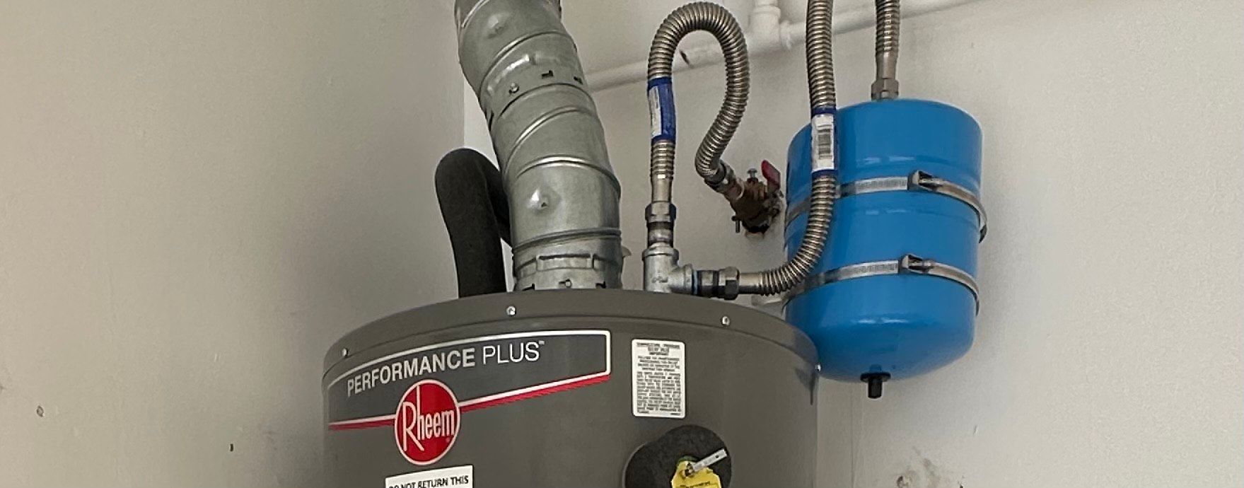 Water heater expansion tank installed above a residential water heater in Encinitas, California, to protect against thermal expansion and excessive water pressure.