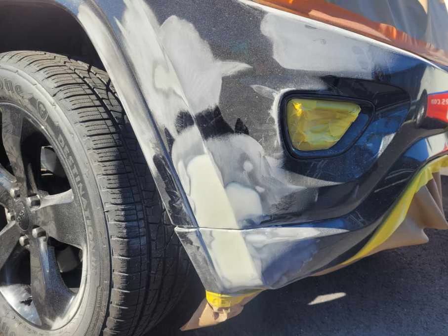 a close up of a car's bumper that is being painted