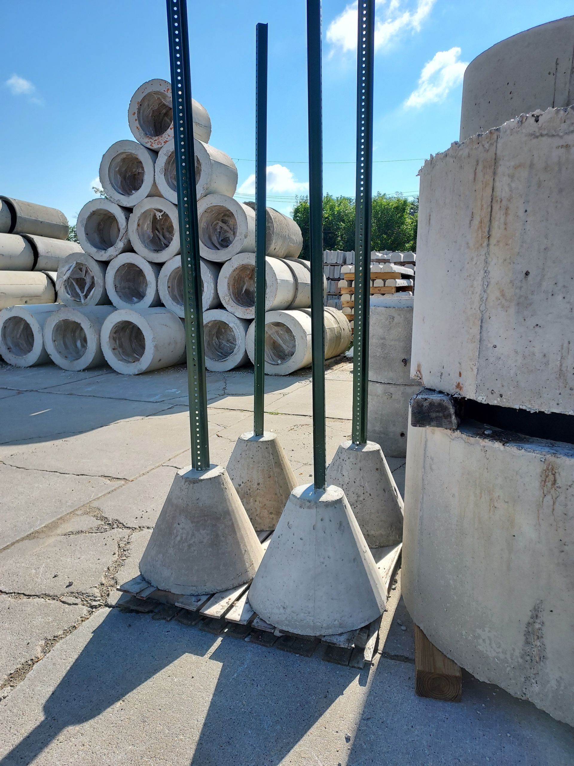 A bunch of concrete sign bases with a holder