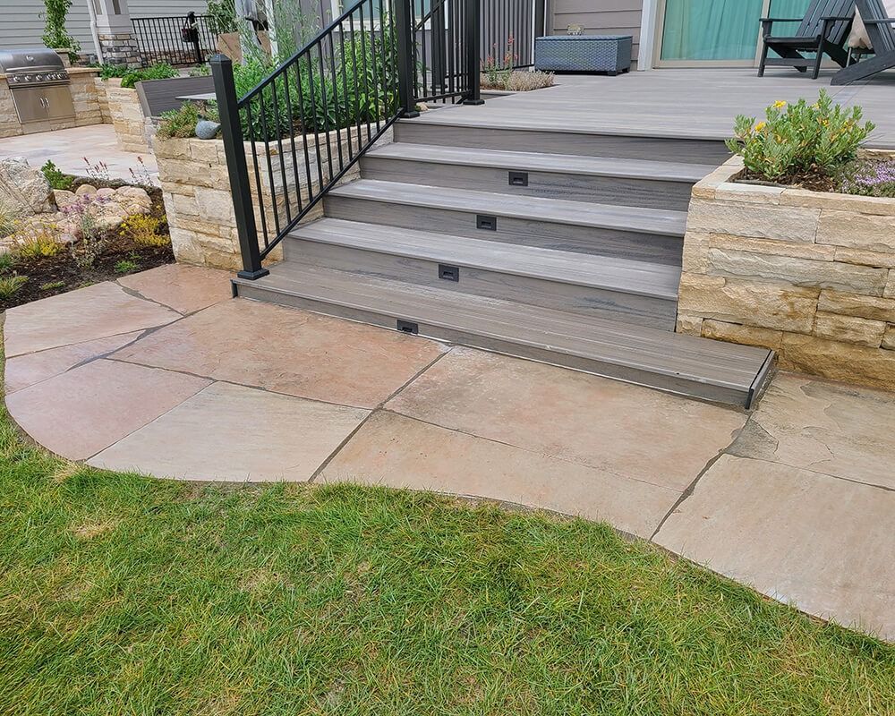 A set of stairs leading up to a deck with a railing.