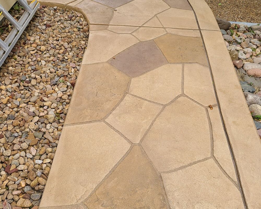 A stone walkway with a ladder in the background