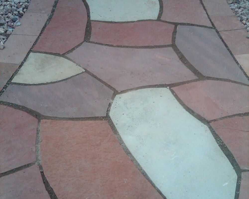 A stone walkway with a stained glass design on it