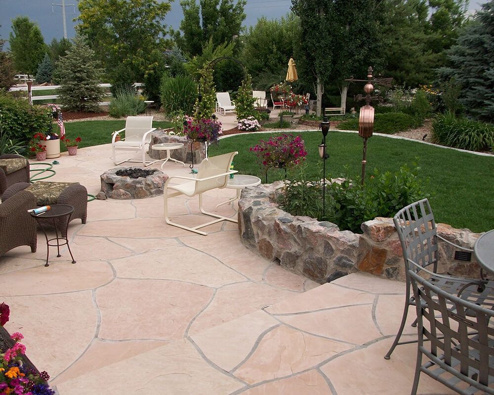 A patio area with a fire pit and chairs