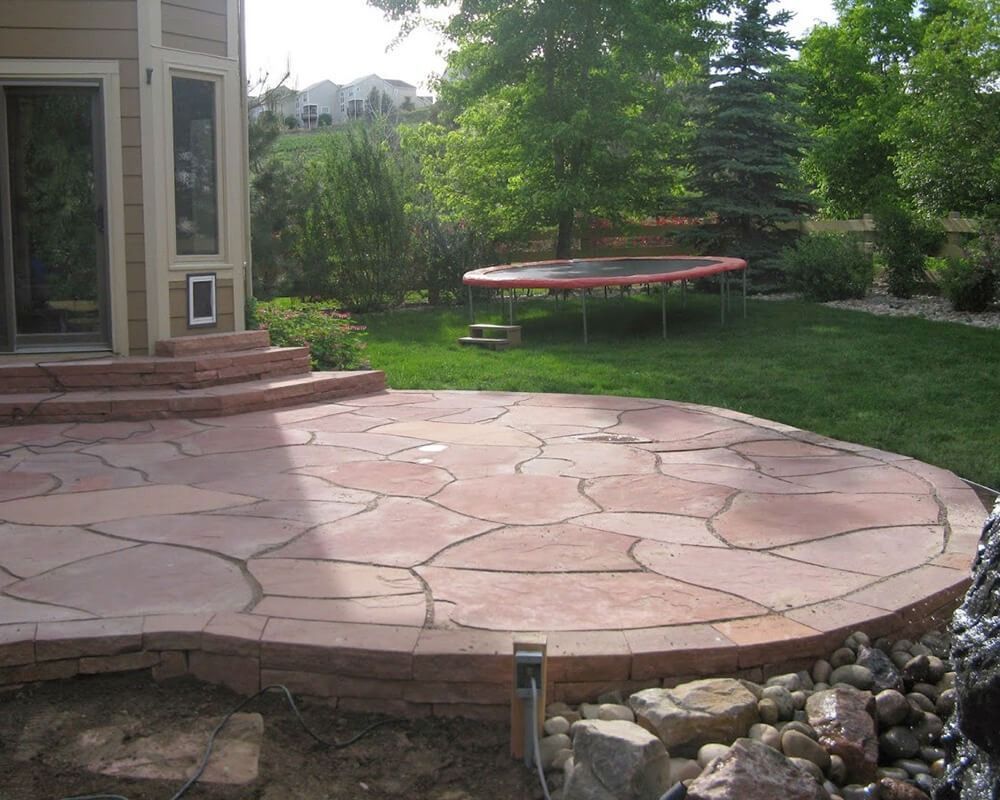 A trampoline is in the backyard of a house