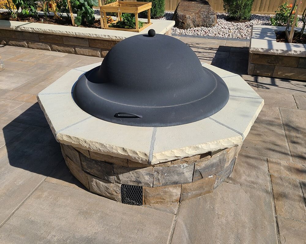 A fire pit with a black dome on top of it