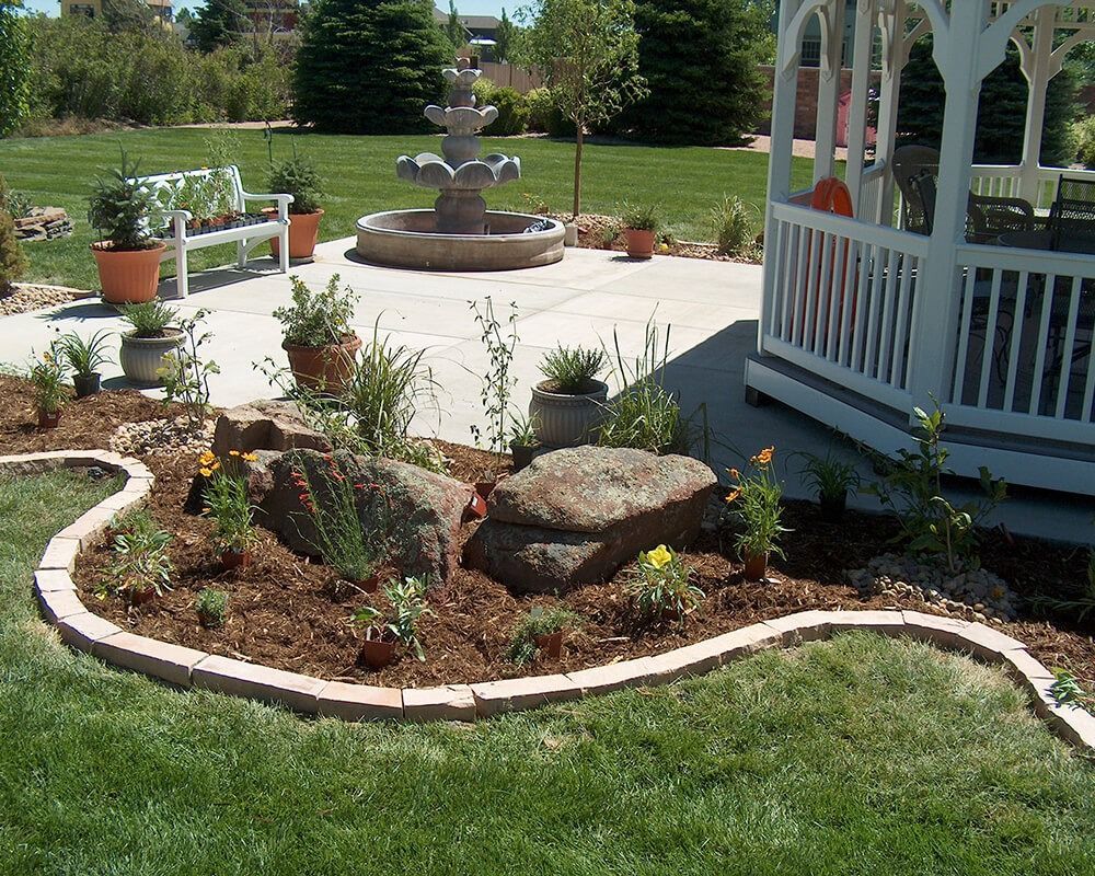 A gazebo with a fountain in the backyard