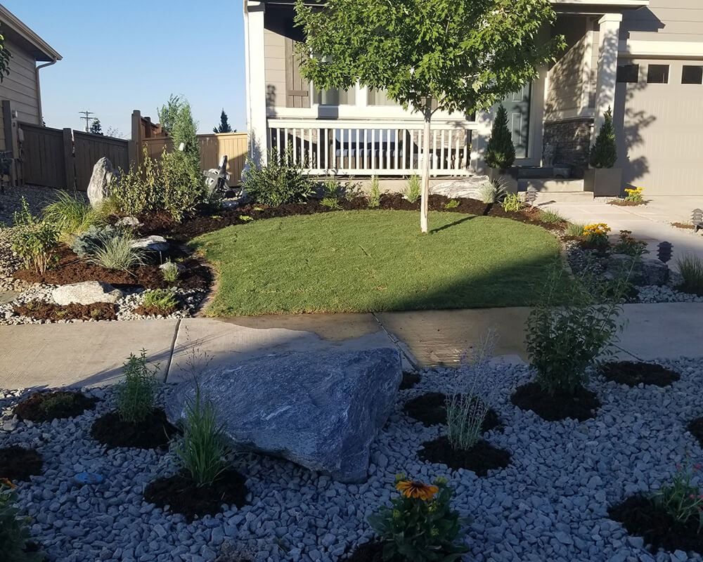 A house with a large rock in front of it