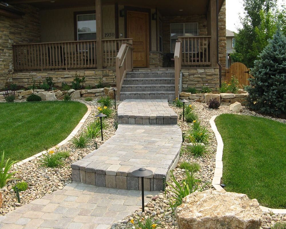 A stone walkway leading to the front door of a house