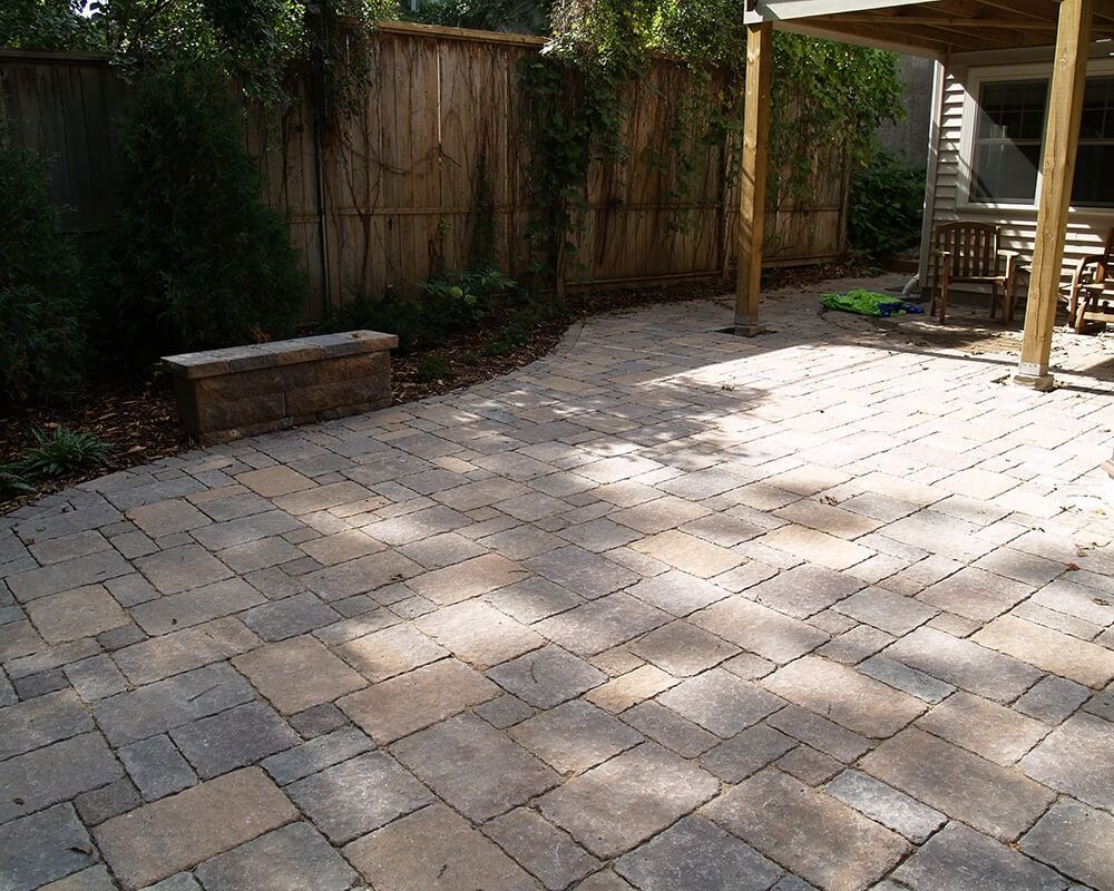 A patio with a wooden fence in the background