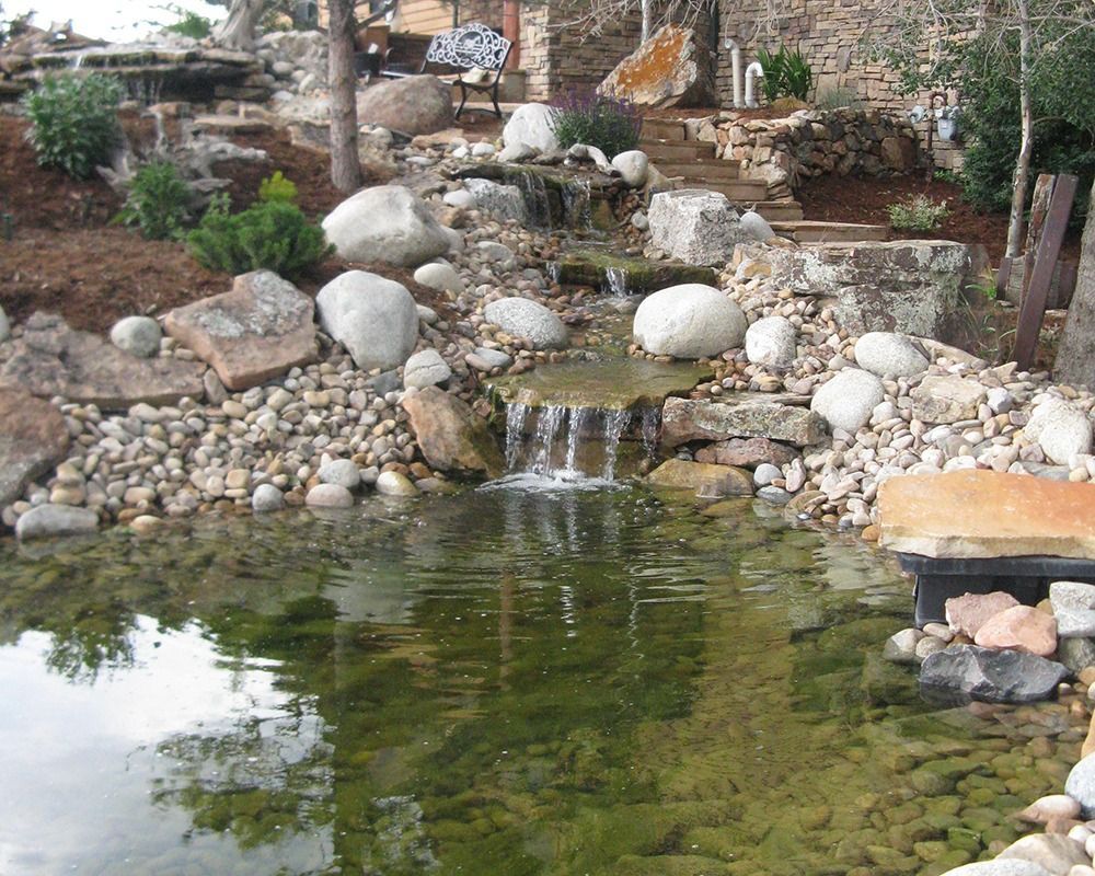 A pond with a waterfall in the middle of it