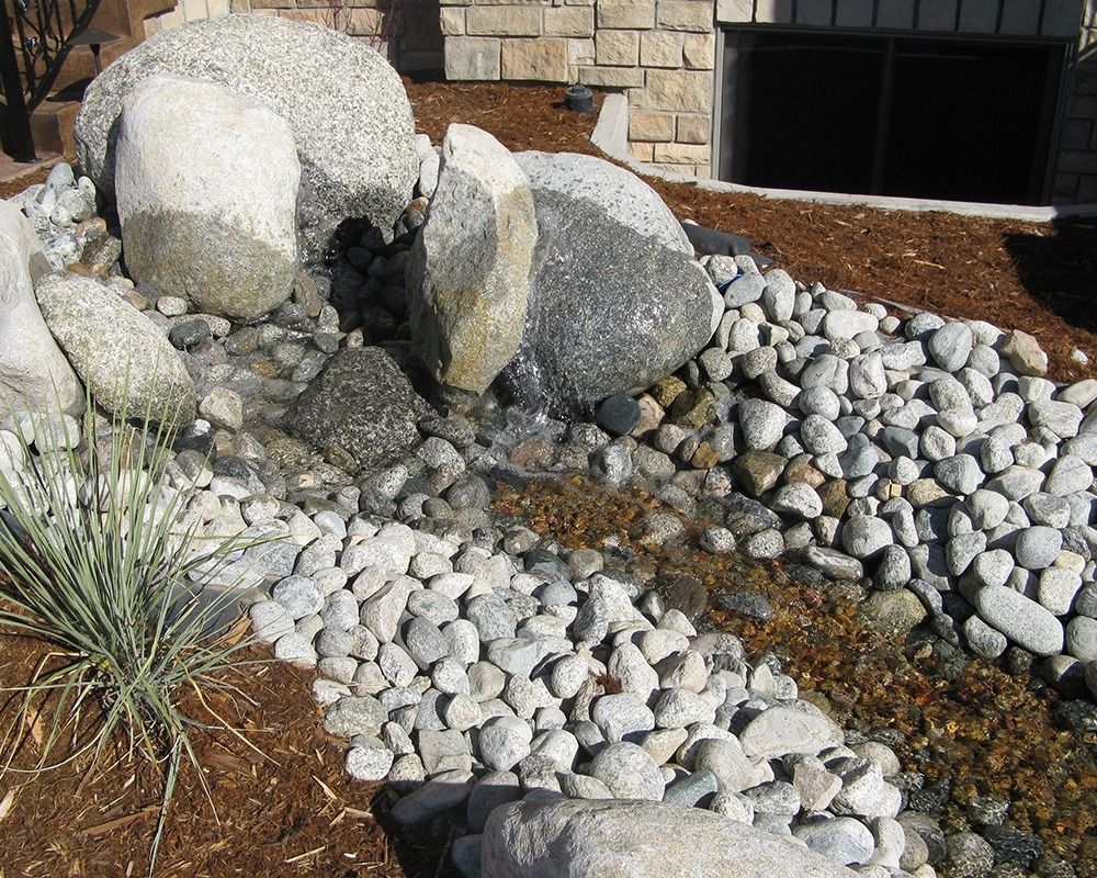 A stream of water is running through a pile of rocks.