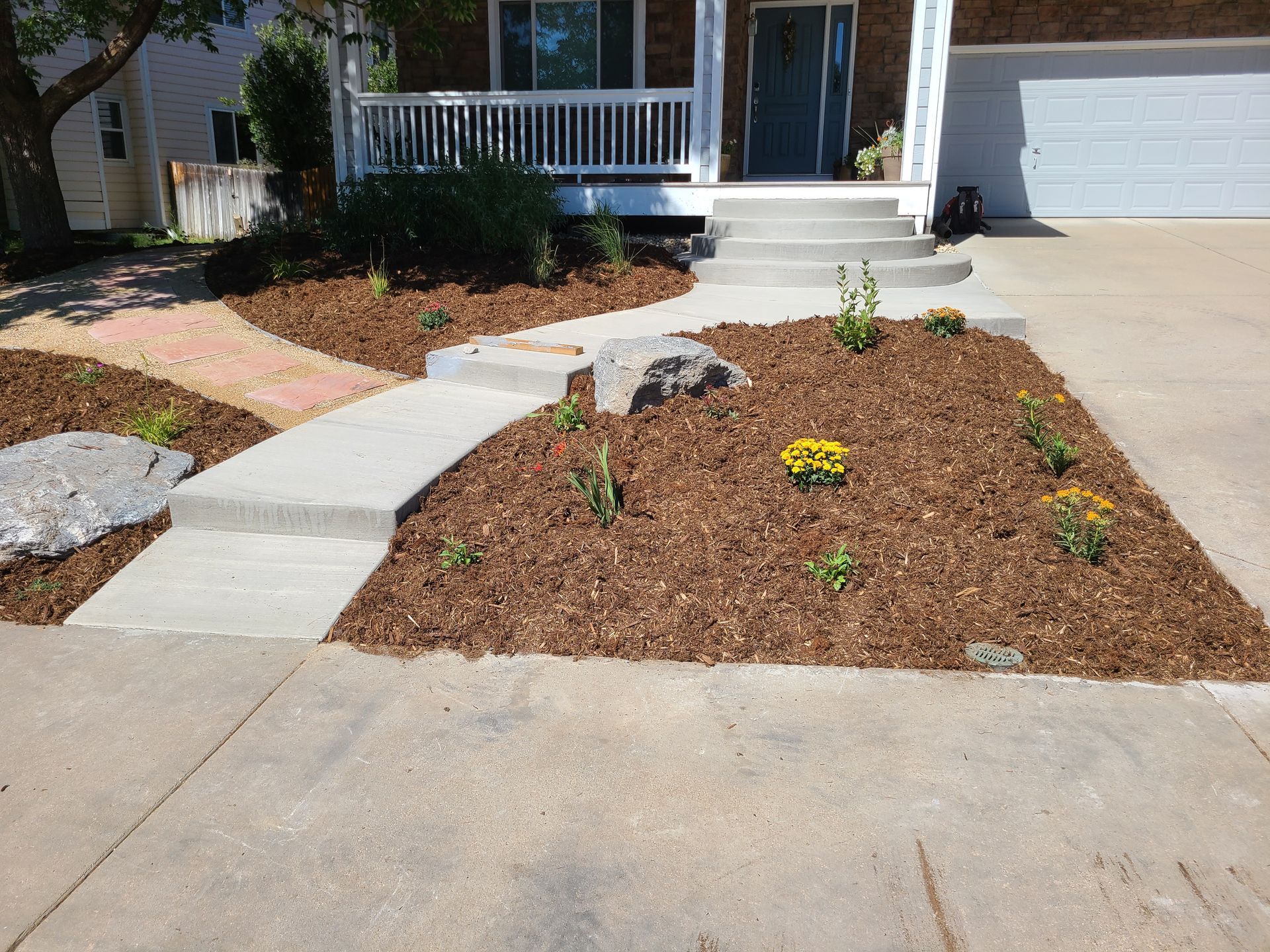 A house with a concrete walkway leading to the front door