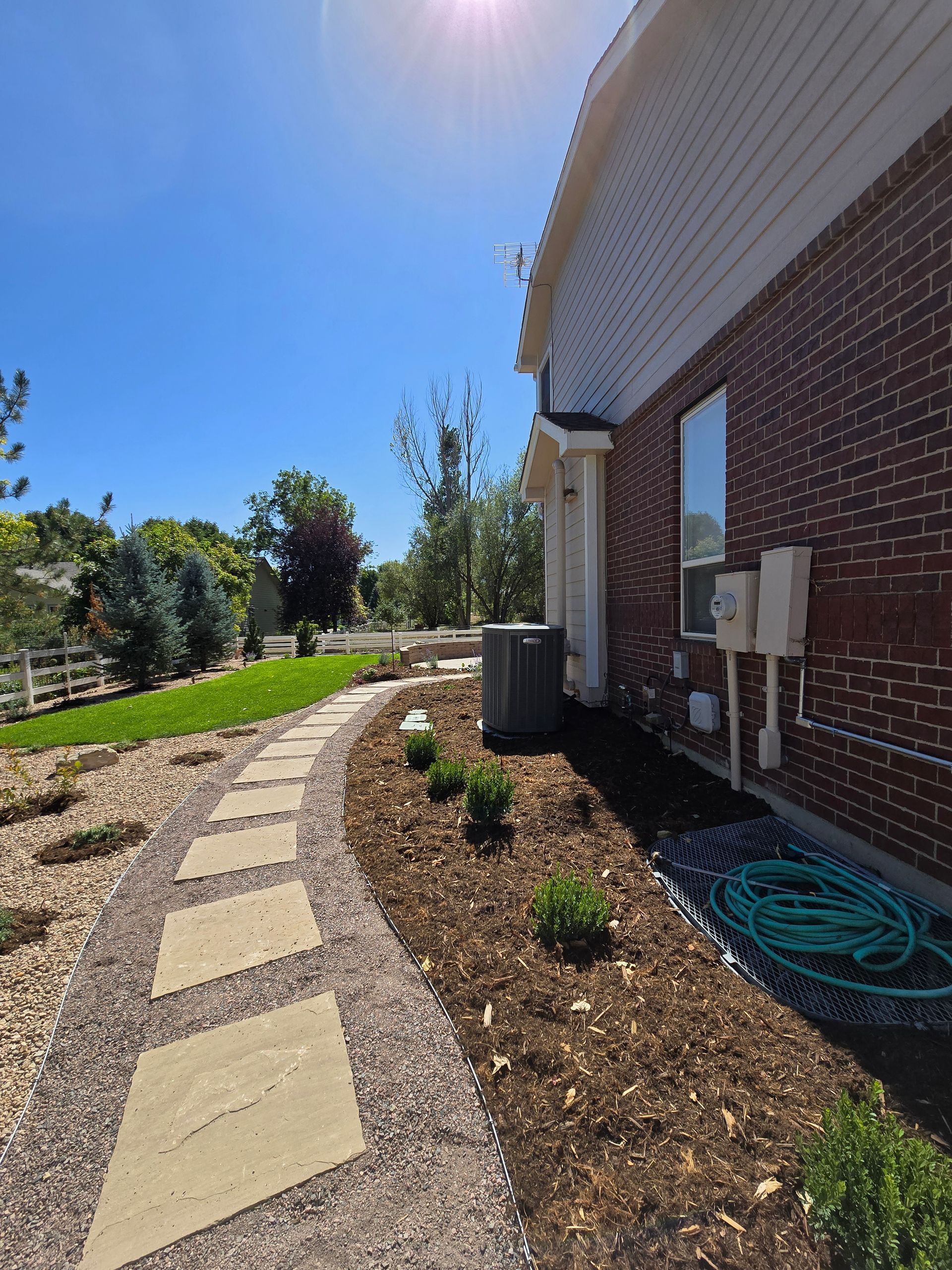 A brick house with a walkway leading to it