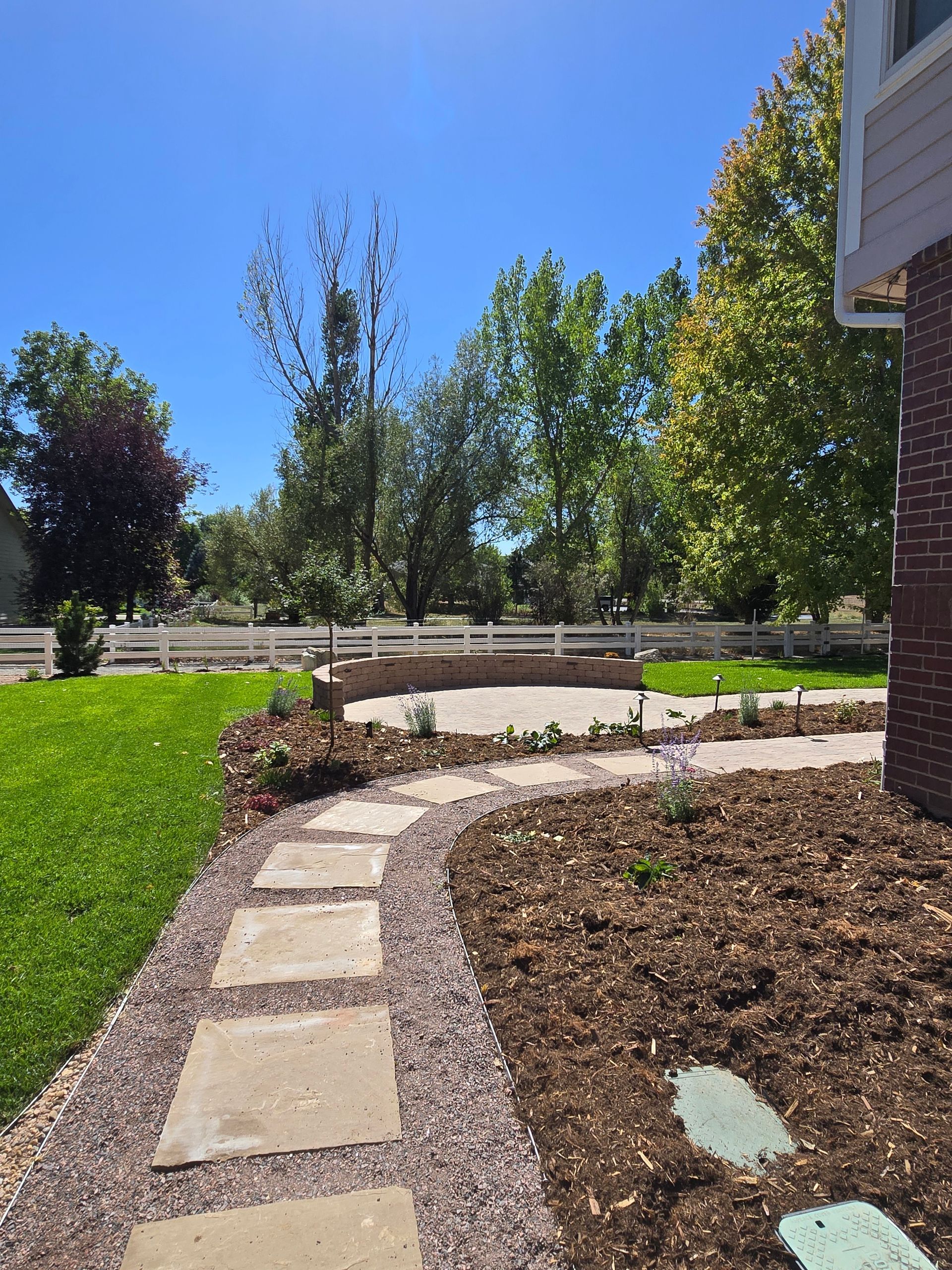 A stone walkway leading to a brick house