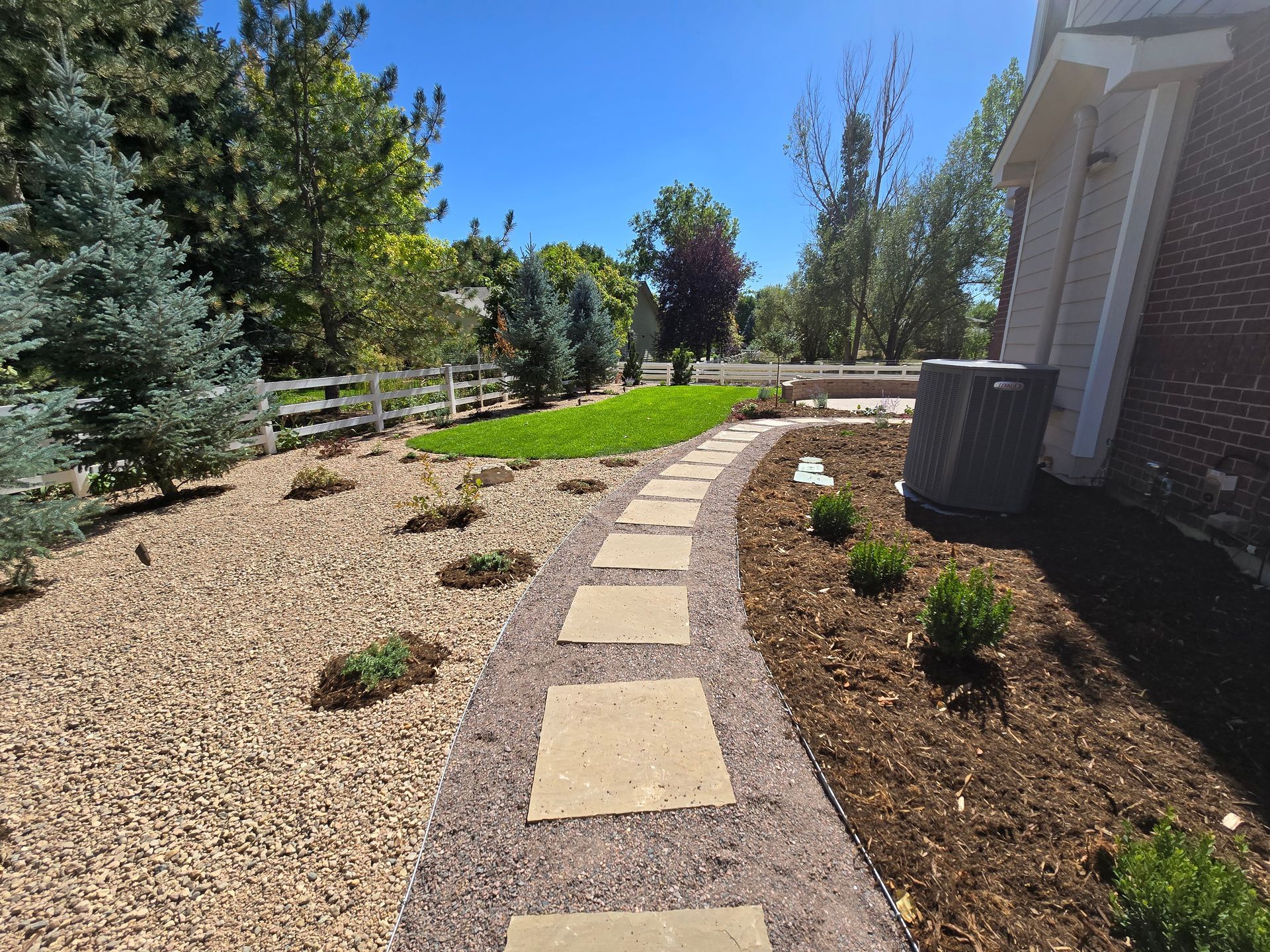 A brick house with a walkway leading to it