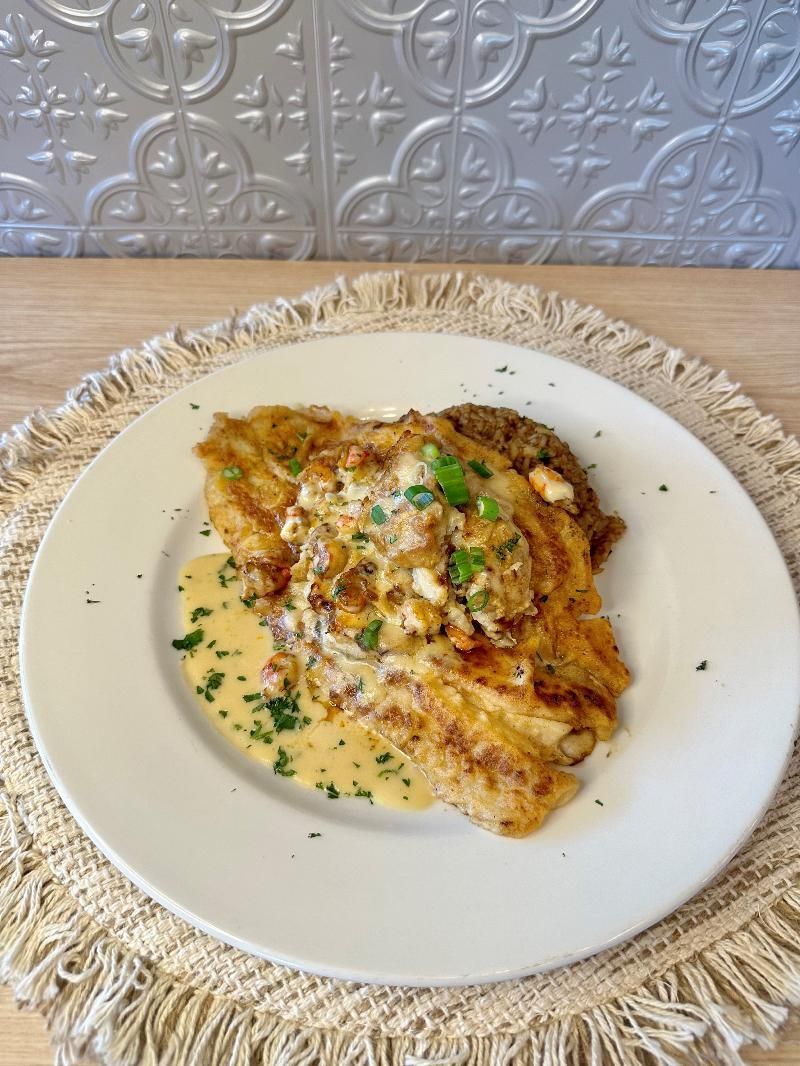 A white plate topped with a piece of food on a table.