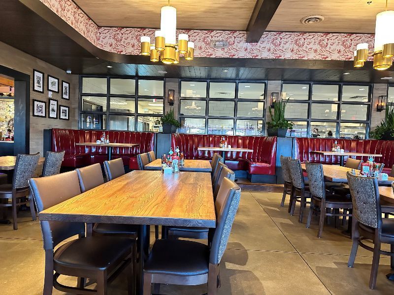 There are many tables and chairs in the restaurant.