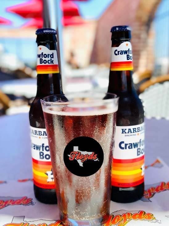 Two bottles of karb crawley beer and a glass of beer on a table