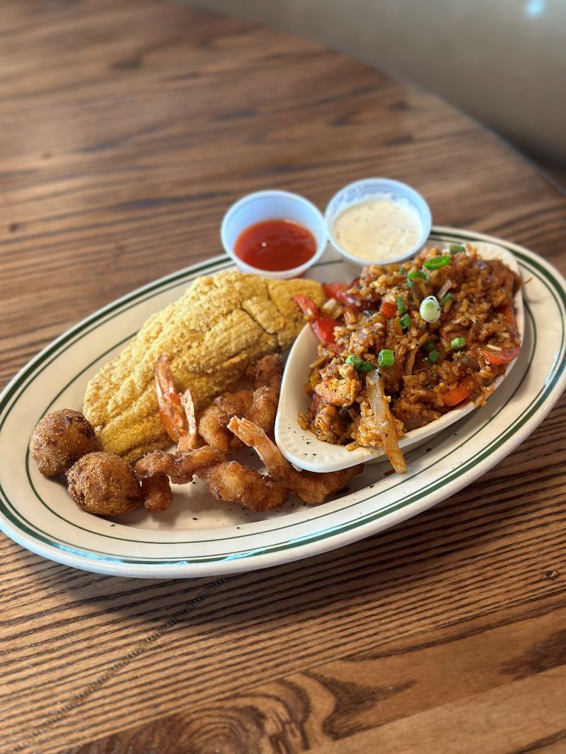 A plate of food is sitting on a wooden table.