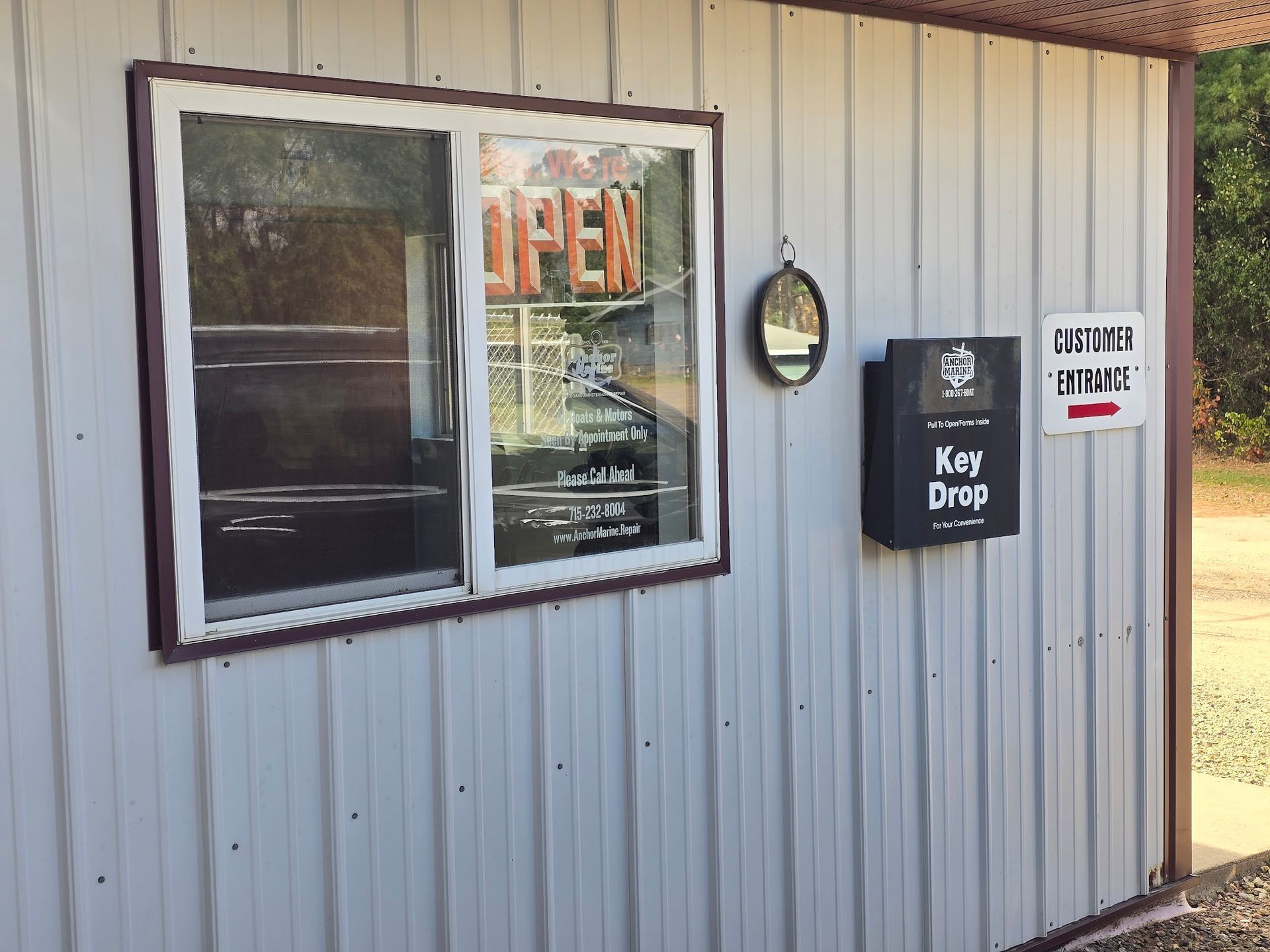 Customer entrance and after hours key drop box at Anchor Marine boat and outboard repair shop in Menomonie Wisconsin serving the Eau Claire and Chippewa Valley area