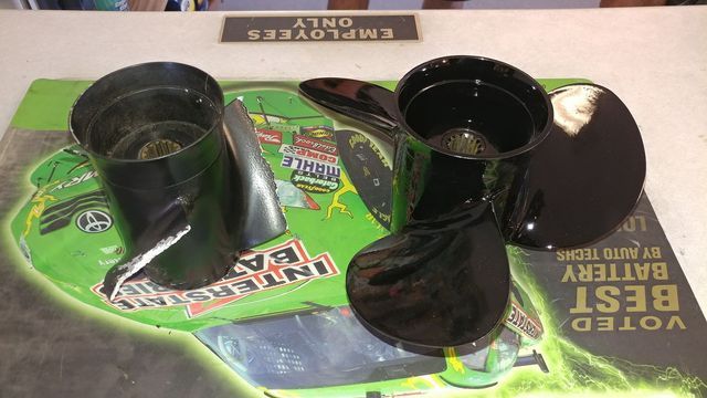 A broken propeller sits on top of a sign that says employees only