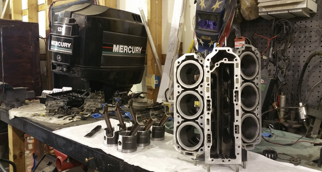 A mercury outboard motor is sitting on top of a table.