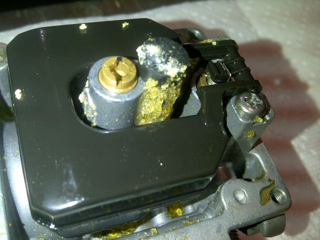 A close up of a piece of metal with a screw in it