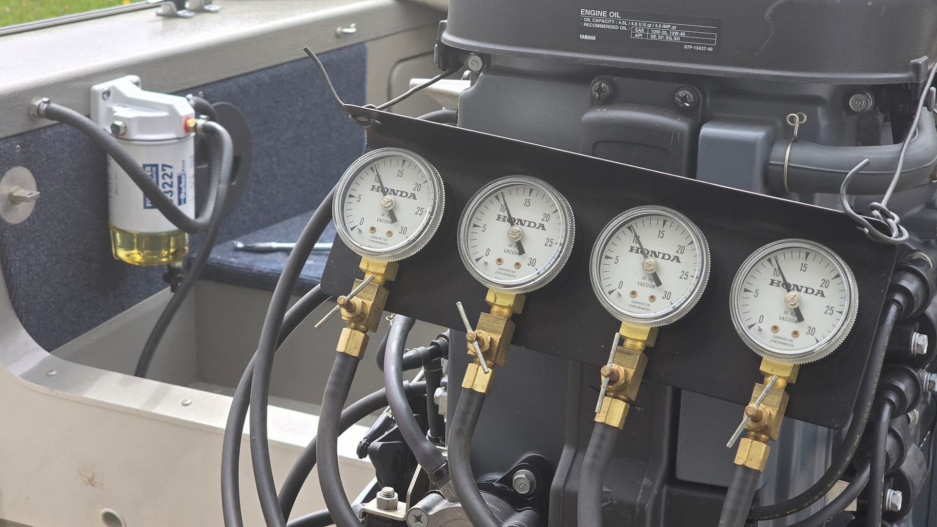 A boat engine with four gauges attached to it