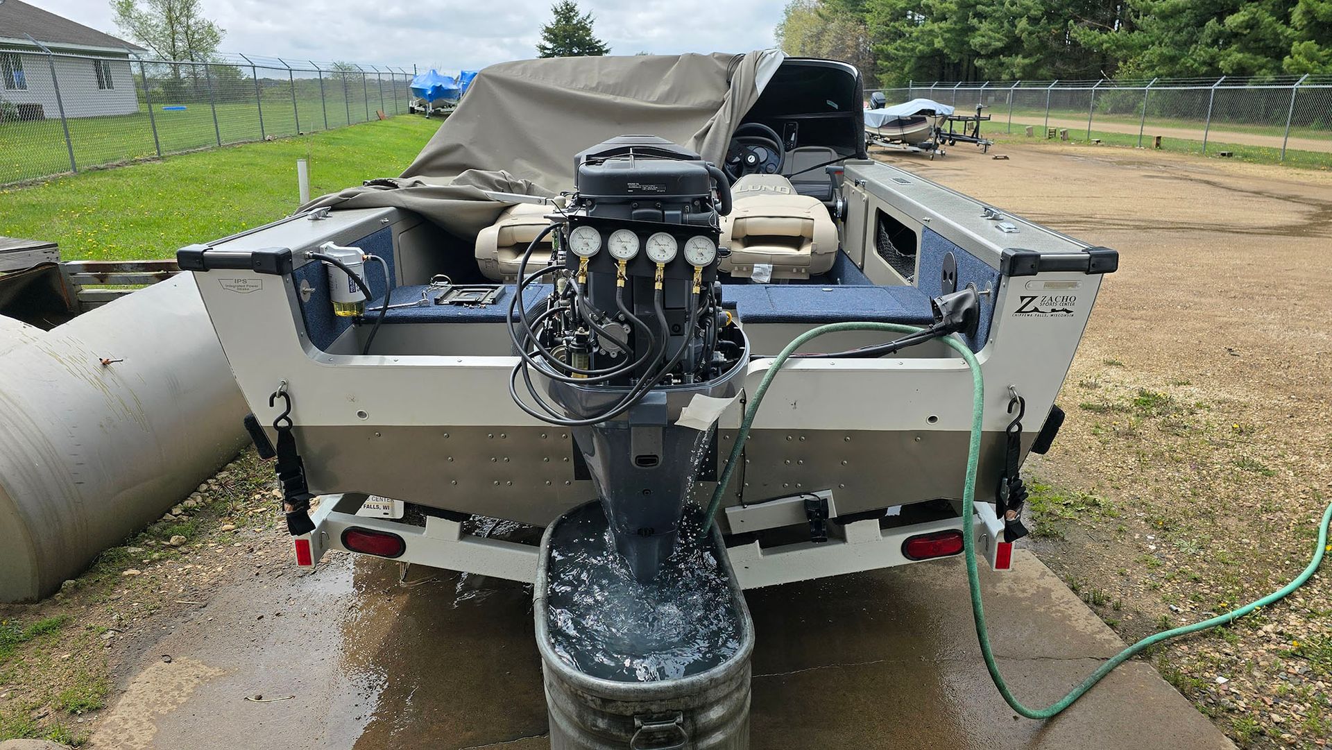 The back of a boat with a hose attached to it.