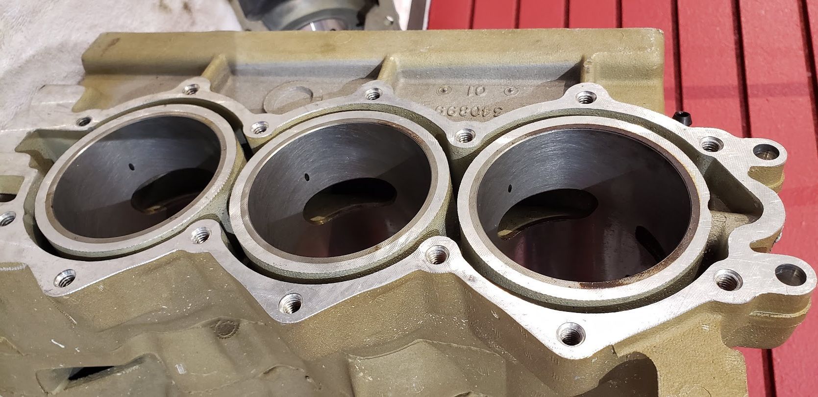 A close up of a cylinder block on a wooden table.