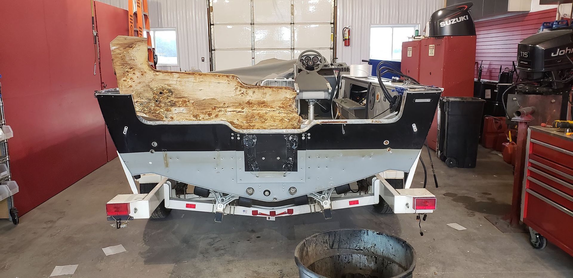 A boat is sitting on a trailer in a garage.
