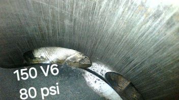 A close up of a metal object with the words `` 150 v6 80 psi '' written on it.